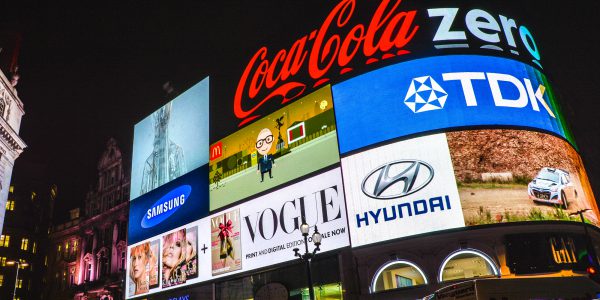 Nighttime photograph of Picadilly circus screens with logos